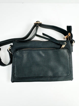 Faux leather crossbody handbag in dark green with zip-top, front flap, and shoulder strap