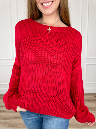 Red knit long-sleeve sweater with wide boat neckline, relaxed fit.