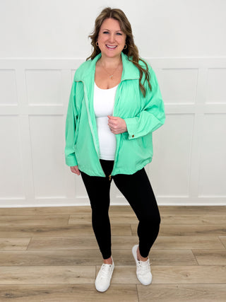 Lightweight hooded long-sleeve jacket in bright green with front zipper and drawstring hem