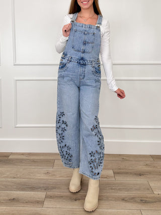 Embroidered medium-wash denim barrel-leg overalls with bib front and floral leg panels