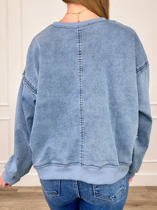 Light blue cotton-blend cropped long-sleeve top, crew neck and back seams