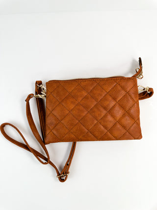Cognac brown quilted faux-leather crossbody bag with zip top and crossbody strap