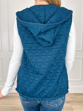 Blue quilted hooded vest back view with diamond stitching and full hood