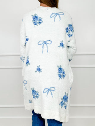 White chenille long sleeve cardigan with blue bow and flower print on back