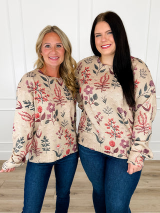 Oat knit long-sleeve sweater with colorful floral print, front view on two women