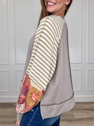 Knit long-sleeve top with striped sleeves, floral contrast cuff, side view