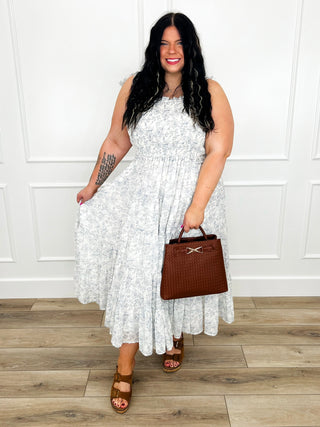 Sleeveless light maxi dress with textured fabric and tiered skirt, brown sandals