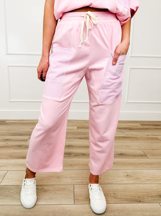 Pink high-rise cotton-blend bottoms with drawstring waist and side cargo pockets