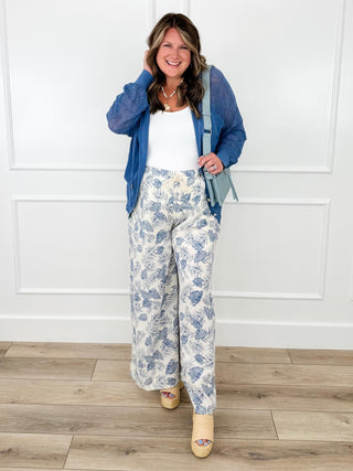 Women's blue jacket outfit with white top and light blue printed wide-leg pants