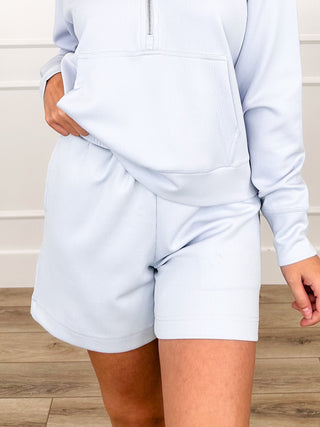 High-rise ribbed shorts in white, close-up front with elastic waistband.