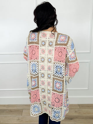 Cream patchwork knit cardigan back with long sleeves and pastel granny-square squares