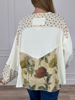 Back of ivory long-sleeve cropped top with floral print panel and dotted yoke