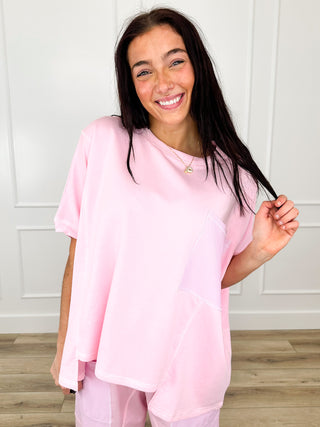 Pink short-sleeve cotton blend top with round neckline and soft drape