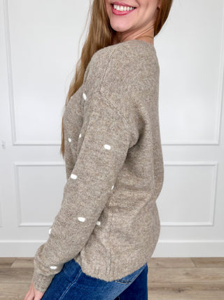 Oatmeal knit long-sleeve sweater with white dot pattern, side view