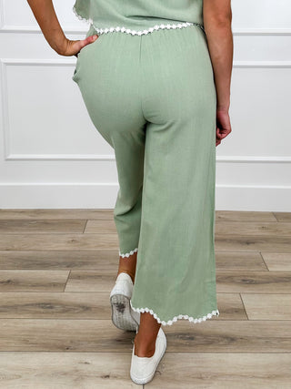 Sage high-rise cropped pants with scalloped ankle hem
