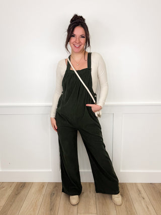 Dark olive wide-leg jumpsuit with spaghetti straps and cardigan, full-length front view