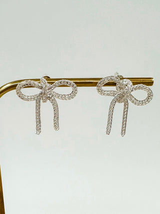 Silver ribbon bow drop earrings with dangling strands on metal bar