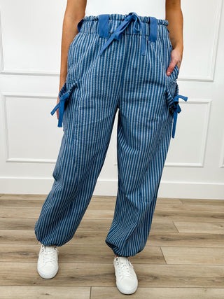 Blue high-rise knit jogger pants with elastic waistband, drawstrings, and side tie bows