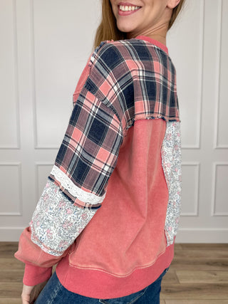 Pink long sleeve top with plaid back and floral print sleeves, rounded crew neck