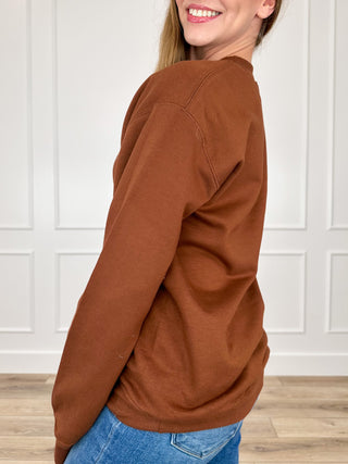 Brown long-sleeve crewneck sweatshirt, side view, ribbed cuffs and hem