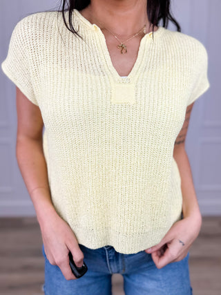 Cream knit short-sleeve V-neck top with subtle ribbed texture