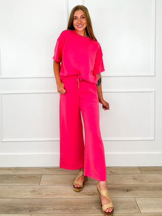 Bright pink high-rise wide-leg bottoms with elastic drawstring waist