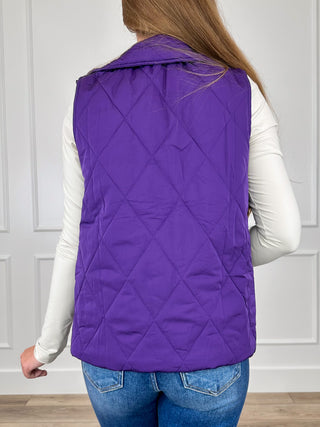 Purple quilted puffer vest back view with hooded collar and snap detail