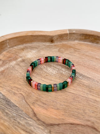 Green and multicolor beaded bracelet with rectangular block beads in pink, blue and white