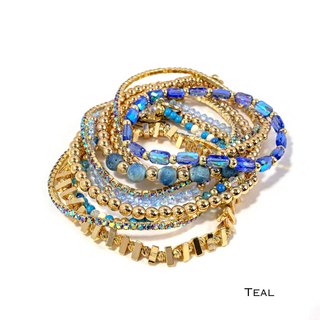 Teal beaded bracelet stack with gold-tone chain, blue rhinestones, and layered cuffs