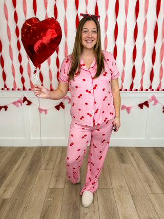 Pink heart-print pajama set with short-sleeve button top and matching pants