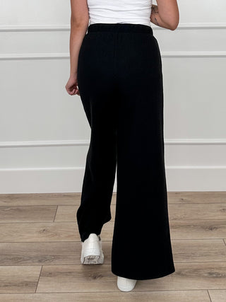 Tell Me This high-rise knit wide-leg pants in black, full front view with elastic waistband
