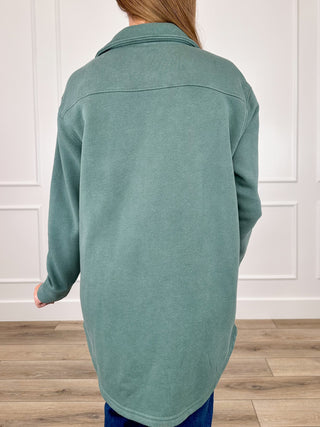 Taupe long-sleeve shacket back view with point collar seam and button placket detail