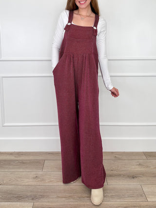 Wine red ribbed overalls with gathered bib and adjustable straps, wide pant legs