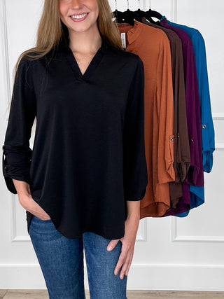 Black gabby top with V-neck and 3/4 roll-tab sleeves, loose tunic hem