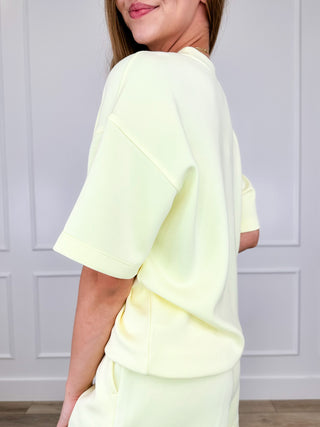 Lightweight short-sleeve crewneck top, pale yellow, side view