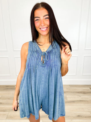 Blue striped sleeveless romper with V-neck tie front and tiered swing hem
