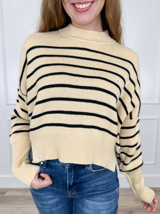 Cream knit cropped sweater top with long sleeves and black striped pattern
