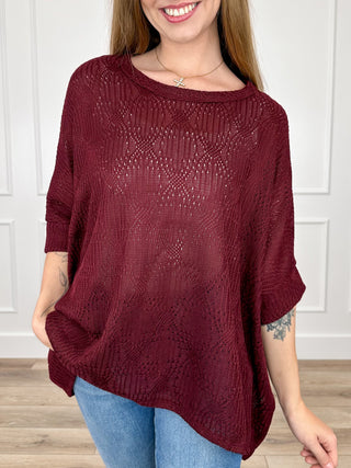 Wine red knit short-sleeve poncho top with open knit stitch texture