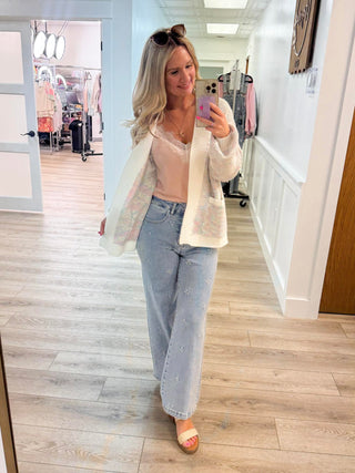 White open cardigan with light top, light blue jeans, tan heeled sandals