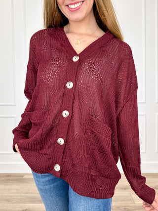 Wine red knit long-sleeve button-up cardigan with V-neck and front patch pockets