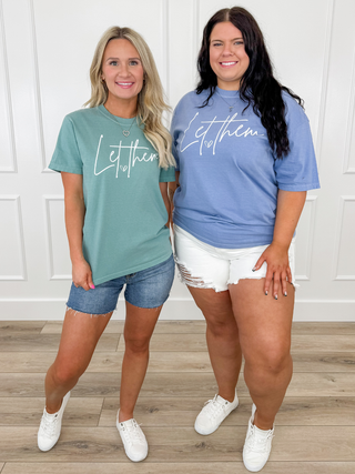 Casual T-shirt outfit with denim shorts, teal and blue tops, white sneakers