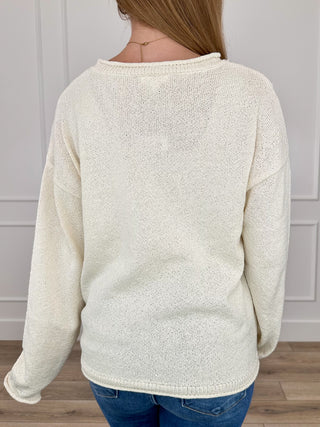 Cream knit long sleeve crewneck sweater, back view with ribbed cuffs
