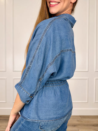 Blue denim short-sleeve button-up top, side view with drawstring waist