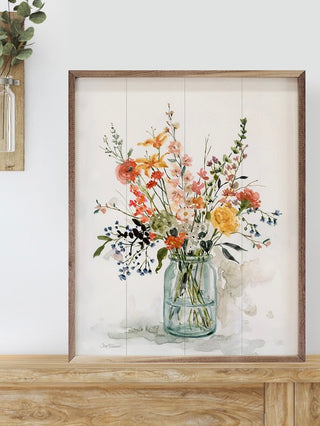 Wood framed sign with watercolor floral bouquet in blue glass vase
