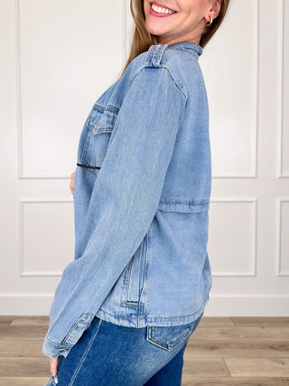 Medium-wash denim jacket with long sleeves, button cuffs, side seam pockets