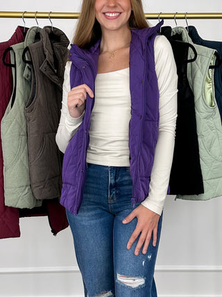 Purple quilted puffer vest with front zipper and side pockets