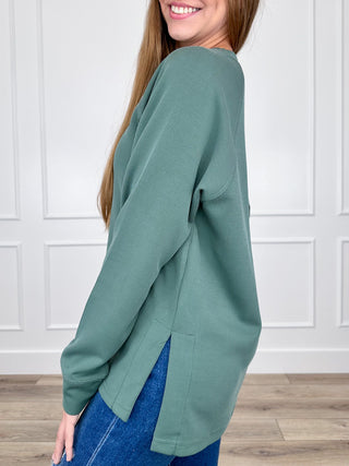 Forest green ribbed long-sleeve raglan top with crew neck, side slit hem
