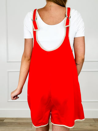 Red romper with white rickrack trim straps and front pockets