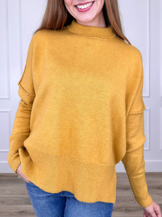 Mustard yellow knit long-sleeve sweater with crew neck and ribbed cuffs