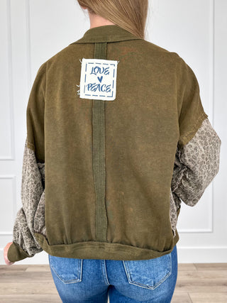 Olive green cotton button-up jacket with patterned sleeves and back label patch